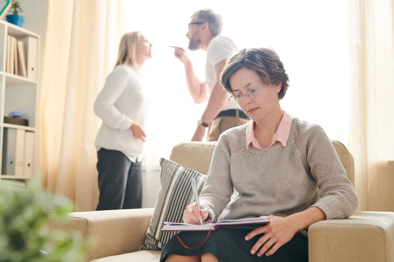 psychologist making notes while couple fighting 2023 11 27 05 03 17 utc